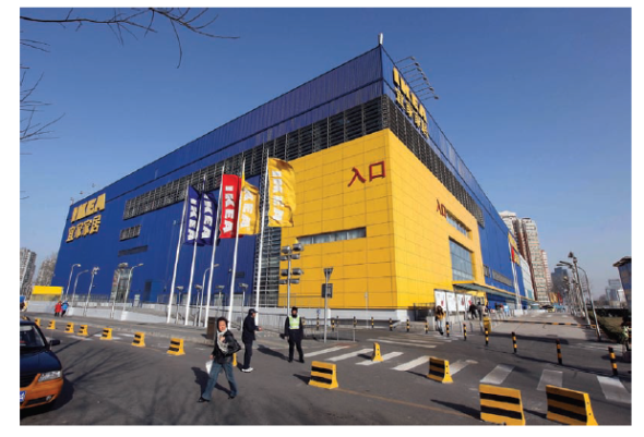 IKEA IKEA has been called one of the most extraordinary success stories in the history of postwar European business. However, the first few years of the twenty-first century were difficult for IKEA, the $31 billion global furniture powerhouse based in Sweden. The euro's strength dampened financial results, as did an economic downturn in Central Europe. The company faces increasing competition from hypermarkets, do-it-yourself retailers such as Walmart, and supermarkets that are expanding into home furnishings. During his tenure as CEO from 1999 to 2009, Anders Dahlvig stressed three areas for improvement: product assortment, customer service, and product availability. With stores in 40 countries, the company's success reflects founder Ingvar Kamprad's social ambition of selling a wide range of stylish, functional home furnishings at prices so low that the majority of people could afford to buy them. The store exteriors are painted bright blue and yellow, Sweden's national colors. Shoppers view furniture on the main floor in scores of realistic-looking settings arranged throughout the cavernous showrooms. At IKEA, shopping is a self-service activity; after browsing and writing down the names of desired items, shoppers can pick up their furniture on the lower level. There, they find flat packs containing the furniture in kit form; one of the cornerstones of IKEA's low-cost strategy is having customers take their purchases home in their own vehicles and assemble the furniture themselves. The lower level of a typical IKEA store also contains a restaurant, a grocery store called the Swede Shop, a supervised play area for children, and a baby care room. IKEA's unconventional approach to the furniture business has enabled it to rack up impressive growth in an industry in which overall sales have been flat. Sourcing furniture from a network of more than 1,600 suppliers in 55 countries helps the company maintain its low-cost, high-quality position. During the 1990s, IKEA expanded into Central and Eastern Europe. Because consumers in those regions have relatively little purchasing power, the stores offer a smaller selection of goods; some furniture is designed specifically for the cramped living styles typical in former Soviet bloc countries. Exhibit 16-11 IKEA currently has eleven stores in China; the Xu Hui store in Shanghai is one of the Swedish company's top performers by revenues. In keeping with IKEA's standardized global retail concept, the Chinese stores are spacious and clean. All locations feature restaurants where visitors can enjoy Swedish meatballs and other meal items. In some cases, the restaurants have also become a favorite meeting place for dating clubs that allow older Chinese to socialize. Source: Doug Kanter/Bloomberg via Getty Images. Throughout Europe, IKEA benefits from the perception that Sweden is a source of high-quality products and efficient service. Currently, Germany and the United Kingdom (UK) are IKEA's top two markets. The United Kingdom represents IKEA's fastest-growing market in Europe. Although Britons initially viewed the company's less-is-more approach as cold and too Scandinavian, they were eventually won over. IKEA currently has 18 stores in the UK, and plans call for opening more in this decade. As Allan Young, creative director of London's St. Luke's advertising agency, noted, IKEA is anticonven- tional. It does what it shouldn't do. That's the overall theme for all IKEA ads: liberation from tradition. In 2005, IKEA opened two stores near Tokyo; more stores are on the way as the company expands in Asia. IKEA's first attempt to develop the Japanese market in the mid-1970s resulted in failure. Why? As Tommy Kullberg, former chief executive of IKEA Japan, explained, In 1974, the Japanese market from a retail point of view was closed. Also, from the Japanese point of view, I do not think they were ready for IKEA, with our way of doing things, with flat packages and asking the consumers to put things together and so on. However, demographic and economic trends are much different today. After years of recession, consumers are seeking alternatives to paying high prices for quality goods. Also, IKEA's core customer segment-post-baby boomers in their thirties-grew nearly 10 percent between 2000 and 2010. In Japan, IKEA will offer home delivery and an assembly service option. The coming years will bring big changes at IKEA. In 2013, Peter Agnefjall became the company's new chief executive. He plans to continue the company's sustainability initiatives, including the possibility of leasing kitchens to consumers. As Steve Howard, chief sustainability officer, said, We want a smarter consumption, and maybe people are less attached to ownership. However, some observers question IKEA's sustainability bona fides, noting that its low-priced furniture contributes to a throw it away mentality when a piece breaks. Howard responds to such criticism by noting that People have needs to be met-they need wardrobes, sofas, kitchens. The most important thing is to meet those needs in the most sustainable way possible. For example, in France, one factory sources half its wood from recycled IKEA products that are ground up and repurposed as bookshelves, tables, and other new products. What does it mean to say that, in terms of Porter's generic strategies, IKEA pursues a strategy of cost focus?
