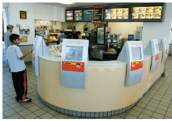 Just Swipe It Ordering food has not changed for 30 to 40 years. Now, McDonald's is ready to change how you pay for your Happy Meal in Europe with touch screens and swipe cards. They will also be revamping their menu and introducing longer opening hours to make it easier for their customers and improve efficiency. McDonald's is also looking forward to harvesting more information about their customers' ordering habits. The people of the United Kingdom will shortly be able to swipe their Visa debit cards as simply as their Oyster cards. (The Oyster card is a form of electronic ticketing used on public transport services within the Greater London area of the United Kingdom.) They may also introduce roving waiters with handheld terminals to assist customers with extra products such as ice cream cones without them having to return to the till. This move has been triggered by the pervasive use of technology in Japan, whose citizens currently use their mobile phone for tickets. On the bright side, (1) you will not have to repeat your order several times, (2) you can get a McDonald's meal without having cash in your wallet, and (3) the ordering process will speed up, thereby reducing the lines. On the not-so-bright side, (1) expect thousands to lose their jobs, and (2) McDonald's may act like Google and log, monitor, and do analytics of your buying behavior. At a time when many retail and consumer companies are racking up sluggish or even shrinking sales in Europe, McDonald's like-for-like sales rose 5.7 percent year-on-year in the first quarter and McDonald's North American sales were up 2.9 percent in 2011-the highest growth out of its three main geographic regions. McDonald's reduced the locations in Europe, but the U.S. company is looking for 50,000 new employees. McDonald's new system could face criticism in a sensitive time just months from a global recession when people are still struggling to find jobs. Why?