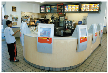 Just Swipe It Ordering food has not changed for 30 to 40 years. Now, McDonald's is ready to change how you pay for your Happy Meal in Europe with touch screens and swipe cards. They will also be revamping their menu and introducing longer opening hours to make it easier for their customers and improve efficiency. McDonald's is also looking forward to harvesting more information about their customers' ordering habits. The people of the United Kingdom will shortly be able to swipe their Visa debit cards as simply as their Oyster cards. (The Oyster card is a form of electronic ticketing used on public transport services within the Greater London area of the United Kingdom.) They may also introduce roving waiters with handheld terminals to assist customers with extra products such as ice cream cones without them having to return to the till. This move has been triggered by the pervasive use of technology in Japan, whose citizens currently use their mobile phone for tickets. On the bright side, (1) you will not have to repeat your order several times, (2) you can get a McDonald's meal without having cash in your wallet, and (3) the ordering process will speed up, thereby reducing the lines. On the not-so-bright side, (1) expect thousands to lose their jobs, and (2) McDonald's may act like Google and log, monitor, and do analytics of your buying behavior. At a time when many retail and consumer companies are racking up sluggish or even shrinking sales in Europe, McDonald's like-for-like sales rose 5.7 percent year-on-year in the first quarter and McDonald's North American sales were up 2.9 percent in 2011-the highest growth out of its three main geographic regions. McDonald's reduced the locations in Europe, but the U.S. company is looking for 50,000 new employees. There is no word yet on whether or not McDonald's plans to bring the technology to North America. Why? SOURCES: Louise Lucas, McDonald's to Introduce Swipe Cards to Europe, Financial Times, May 16, 2011, B4; and Irwin Allen Rivera, McDonald's goes hi-tech: touch the screen to order, swipe card to pay, May 17th, 2011, http://technoodling.net/mcdonalds-goes-hi-tech-touch-the-screen-to-order-swipe-card-to-pay.