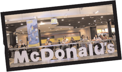 McDonald's McDonald's is the world's leading hamburger fast-food chain, with over 32,000 restaurants in 118 countries. More than 75 percent of McDonald's restaurants are owned and operated by franchisees, which decreases the risk associated with expansion and ensures longterm tenants for the company. McDonald's serves 58 million people each day and promises a simple, easy, and enjoyable food experience for its customers. The history of the McDonald's Corporation dates back to 1955 when Ray Kroc, a multimixer salesman, franchised a hamburger restaurant from the McDonald brothers, named it McDonald's, and offered simple foods such as the famous 15 cent hamburger. Kroc helped design the building, which featured red and white sides and a single golden arch to attract local attention. Ten years later, 700 McDonald's restaurants existed around the country, and the brand was on its way to becoming a household name. During the 1960s and 1970s, Kroc led McDonald's growth domestically and internationally while pushing the importance of quality, service, cleanliness, and value. The menu expanded to include the Big Mac, Quarter Pounder, Happy Meal, Filet-O-Fish, and breakfast items like the Egg McMuffin. Kroc also understood early on that his core audience consisted of children and families. Therefore, he focused McDonald's advertising efforts at these groups and introduced Ronald McDonald in 1965 during a 60-second commercial. Soon, characters such as Grimace, the Hamburgler, and Mayor McCheese made their debut in McDonald's advertising campaigns and helped lure children into its restaurants for simple, good-tasting food, and a fun experience. It was also during this time that McDonald's created the Ronald McDonald House, which opened in 1974 to help children with leukemia. Since then, it has expanded into a global charity effort called Ronald McDonald House Charities that strives to improve children's lives, health, and well-being through three major programs: Ronald McDonald House, Ronald McDonald Family Room, and Ronald McDonald Care Mobile. McDonald's aggressively expanded overseas throughout the 1980s by adding locations throughout Europe, Asia, the Philippines, and Malaysia. This rapid expansion, however, led to many struggles during the 1990s and early 2000s. The company lost focus and direction, expanding by as many as 2,000 new restaurants a year. New employees weren't trained fast or well enough, all of which led to poor customer service and dirtier restaurants. New competitors popped up and the company acquired nonburger companies, Chipotle and Boston Market (which were eventually sold in 2006 and 2007). Consumer tastes changed, and new products like pizza, the Arch Deluxe, and deli sandwiches failed to connect with consumers, as did tweaks to the current menu including multiple changes to the Big Mac special sauce. Jim Skinner, McDonald's chief executive explained, We got distracted from the most important thing: hot, high-quality food at a great value at the speed and convenience of McDonald's. In 2003, McDonald's implemented a strategic effort called the Plan to Win. The framework, which still exists today, helped McDonald's restaurants refocus on offering a better, higher-quality consumer experience rather than a quick and cheap fast-food option. The Plan to Win playbook provided strategic insight on how to improve on the company's 5 Ps-people, products, promotions, price, and place-yet allowed local restaurants to adapt to different environments and cultures. For example, McDonald's introduced a Bacon Roll breakfast sandwich in the United Kingdom, a premium M burger in France, and an egg, tomato, and pepper McPuff in China. Prices also varied slightly across the United States to better reflect different tastes in different regions. Some food changes that helped turn the company around included offering more chicken options as beef consumption started to decline, selling milk in a bottle instead of a carton, and removing Super Size options after the documentary Super Size Me targeted McDonald's and its link to obesity. McDonald's responded to health trends and began offering premium salads as well as apple slices instead of French fries in Happy Meals as well as all-white-meat McNuggets. While many of the healthier options targeted moms and held a premium price, McDonald's introduced the $1 menu at the same time, which targeted the lower-income bracket and teenagers. Other responses included improving drive-thru service since 60 percent of McDonald's U.S. business came from drive-thrus, introducing more snack options, and refurbishing restaurants with leather seats, warmer paint colors, and flat-screen TVs. Initial results were staggering; from 2003 to 2006, the stock price increased 170 percent. Sales continued to increase through the late 2000s and topped $23.5 billion in 2008, making McDonald's one of only two companies in the Dow Jones Industrial Average whose share price rose in 2008. McDonald's continued to flourish in 2009, led by its premium Angus burgers and its McCafé coffee line, which directly targeted competitors like Starbucks with less expensive specialty coffee drinks. McDonald's also launched a worldwide repackaging effort as a result of intense consumer research. The new packaging aimed to accomplish several tasks, including teaching consumers about McDonald's health consciousness and building awareness of its use of locally grown produce. It included bold text and full-color photographs of real ingredients like potatoes on French fry packaging and vegetables, cheese, and cooking utensils on hamburger packaging. Mary Dillon, McDonald's global chief marketing officer, explained that the goal is to create unique personalities for our menu items by telling a story about each one. Through the years, McDonald's has created a number of successful marketing campaigns and slogans such as You Deserve a Break Today, It's a Good Time for the Great Taste of McDonald's, and Food, Folks, and Fun. Its current campaign, I'm Lovin' It, seems on track to join the others by helping the company reach record sales and growth despite difficult economic times. What risks do you feel McDonald's will face going forward?