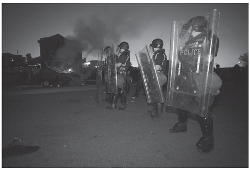 Caught in the War Zone MIKE GRUNDMANN AND ROGER SOENKSEN James Madison University War Zone blared the giant headline above photos of fire, vandalism and drunken students being arrested by police in riot gear. This was an out-of-control Springfest, the annual pre-finals block party at James Madison University in Virginia. The Virginia event is but one rite of spring held on college campuses across the nation. Iowa State calls it Veishea and that event has turned ugly more than once over the years. At the University of Colorado's similar event, more than 10,000 people show up to smoke pot. By 2010, on the campus of the University of Virginia, Springfest had ballooned thanks to notices on Facebook that drew students and nonstudents from other states. The 2010 number, estimated to be about 8,000, was about four times larger than previous years according to the Post, and the block party began to get out of control. Two photographers for The Breeze, the twice-weekly student newspaper, had taken hundreds of photos of the event and continued as the crowd grew more unruly, spilling into a nearby neighborhood. According to the Post, President Linwood H. Rose e-mailed the entire 18,500 student campus the following Sunday. Your collective behavior was an embarrassment to your university and a discredit to our reputation, he wrote. No one is opposed to some fun on a beautiful spring weekend, but public drunkenness, destruction of property, and threats to personal safety are unacceptable outcomes. Five days after the melee, the chief local prosecutor, Marsha Garst, was pursuing claims that both attendees and police as well had been assaulted. In trying to find the perpetrators who might have escaped the police dragnet, Garst's office asked The Breeze editor, Katie Thisdell, and a faculty adviser to turn over any unpublished photos so offenders could be identified and arrested. Both refused, on grounds that the paper could not make itself an arm of the law and must remain independent. The next day, Garst, joined by the campus police chief and other law officers, raided the newsroom with a search warrant. It demanded all Springfest photos under threat of confiscating all computers, cameras, cellphones and other devices that could contain the photos. The number of photos seized in this manner was more than 900, according to the Washington Post. Acting on the advice of the Student Press Law Center (SPLC), Thisdell refused, citing the federal Privacy Protection Act (PPA), which shields newspapers from such seizures until they can be challenged in court. The PPA was passed in 1980 just after the state of California had successfully pursued a newsroom search and seizure over the objection of the editors. Interestingly, this case, too, also sprang from a college campus-Stanford University, where the students had photos of ariot on campus and had refused to turn them over. However, this congressional action did not sway Garst, who stuck to her ultimatum. Thisdell, who considered a newsroom emptied of its tools an unacceptable option, relented and turned over all the photos. Thisdell and her advisers alerted news media in the region, and the story went national, including a Washington Post editorial condemning Garst. The Breeze also provided continuous coverage of its own story, but not using any of the staffers directly involved. The state attorney general, Ken Cuccinelli, at a speaking engagement in town, was asked his opinion of Garst's actions. He supported them. A lawyer provided free by the SPLC finally convinced Garst of the Privacy Protection Act's provisions and persuaded her to surrender the photos to a neutral third party so negotiations over the next step could begin. The lawyer advised Thisdell: You can stand by your principle and refuse to turn over any of the photos, but with a plurality of conservative judges, there was a risk of a court order essentially matching the search warrant. Or you can negotiate with Garst to turn over the few photos that show suspects Garst is after. Thisdell, her advisers and her photographers considered the consequences of both choices. Refusing could mean a newsroom shutdown, public accusations of shielding criminals, and weeks, months or years of court appearances. Compromising could embolden future prosecutors, harm The Breeze 's journalistic reputation and discourage important future sources. Thisdell decided to compromise and ultimately turned over 20 photos. As part of the bargain, The Breeze won a public apology from Garst, who said she regretted frightening the student journalists and would follow the law next time. Rober Boag, The Breeze Rober Boag, The Breeze In looking at the typology of duties outlined by Ross in Chapter 1, do the news media have a duty to help law enforcement when it asks for information that only a newsroom has?