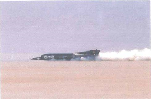 Driving a jet-powered car, Royal Air Force pilot Andy Green broke the sound barrier on land for the first time and achieved a record land speed of more than 763 mi/h in Black Rock Desert, Nevada, on October 15, 1997 (Fig.). (a) What is this speed expressed in m/s (b) How long would it take the jet-powered car to travel the length of a 300-ft football field at this speed ( Hint: v = d/t. ) FIGURE Record run see Exercise.