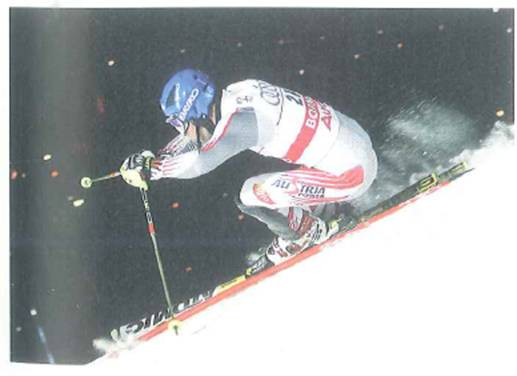 Suppose the slope conditions for the skier shown in Fig. are such that the skier travels at a constant velocity. From the photo, could you find the coefficient of kinetic friction between the snowy surface and the skis If so, describe how this would be done. FIGURE A down slope run See Exercise.