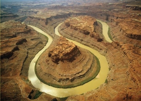 <strong>The below image is a picture of an incised meander. What process would have formed this?</strong> A) Uplift of the land. B) Human engineered channelization. C) A stream becoming more mature and remaining that way. D) A sinkhole.
