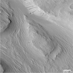 The following is a picture of a landform on Mars.What feature in this picture indicates that Mars may have had running water sometime in the past?