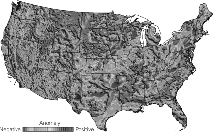 The following picture is a gravity map of the United States.What do the dark gray regions mean in terms of the density of the material below?  