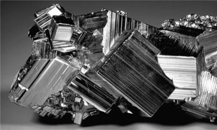 <strong>The image below shows a mineral specimen of pyrite.What is the term for the thin parallel corrugations or stripes shown on the crystal faces below? </strong> A)conchoidal fractures B)facets C)cleavage planes D)striations