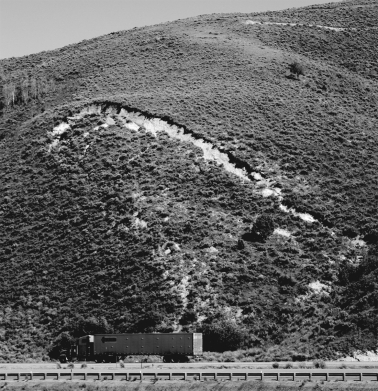 In the figure below,what would be the most effective way to stabilize the slope,assuming that the slope is in a dry,desert environment?