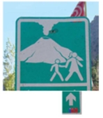 <strong>In this figure the sign shows: </strong> A) the direction towards the volcano. B) the route for evacuation. C) the direction parents should take their kids towards the active volcano site. D) that the volcano is active,so please follow the route. E) both the route for evacuation and that the volcano is active.