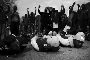 Many activists argue that stop and frisk policing tactics disproportionately profile men of color because over 80 percent of those stopped are African American and Latino. According to these activists, this practice is an example of: