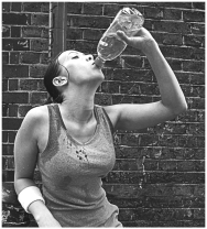 <strong>Examine the figure below. What best explains why the young woman is drinking after her exercise session?</strong> A) Exercise creates body heat, which needs to be eliminated. B) Cold water cools the body and restores the temperature balance-a process known as homeostasis. C) The beverage is most likely a sugar-sweetened soft drink; sugar replenishes the energy lost during exercise. D) Sweating to eliminate excess heat is a source of water loss, which must be replenished if homeostasis is to be maintained.