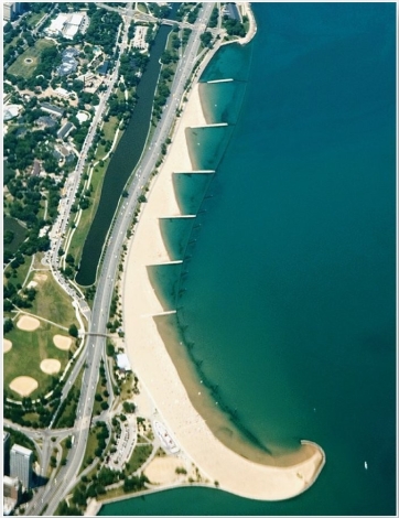 <strong> These features, here from Lake Michigan, disrupt sediment movement along a coast.</strong> A) breakwaters B) groins C) jetties D) tombolos