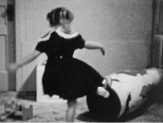 <strong>What is shown in this photo? </strong> A)the use of shaping and positive reinforcement to teach a child self-defense skills B)an experimental demonstration of the cause and effect relationship between watching violent behavior in the media behavior in real life C)a demonstration of the phenomenon of “learned helplessness” in children D)the imitation of an adult's aggressive actions that the child saw in a movie