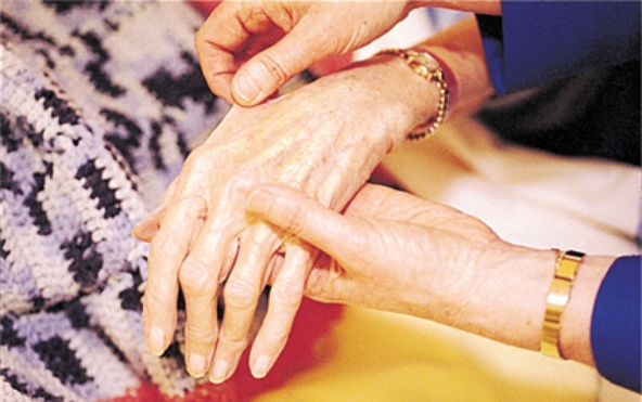<strong>The nurse is assessing a patient's skin. For what is the nurse assessing when using the technique shown in this picture? </strong> A) hydration status B) skin temperature C) skin color D) liver function