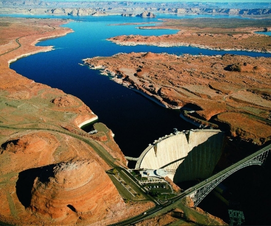 Examine the photo of Glen Canyon Dam in Arizona and the reservoir called Lake Powell that formed upstream of it. Describe what has happened to base level on the Colorado River at this location since the dam was constructed. Make a prediction for what will happen at this location over the next several hundred years.