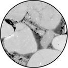 <strong>What is the material surrounding the grains in the photo?  </strong> A) cement B) air C) molten rock D) water <div style=padding-top: 35px> 