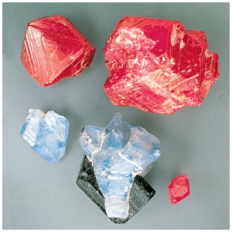 <strong>The natural samples of corundum pictured below show variations of color from red (ruby)to blue (sapphire).The differences in color is best explained by: </strong> A)polymerization B)crystal structure C)the principle of atomic substitution D)polymorphism