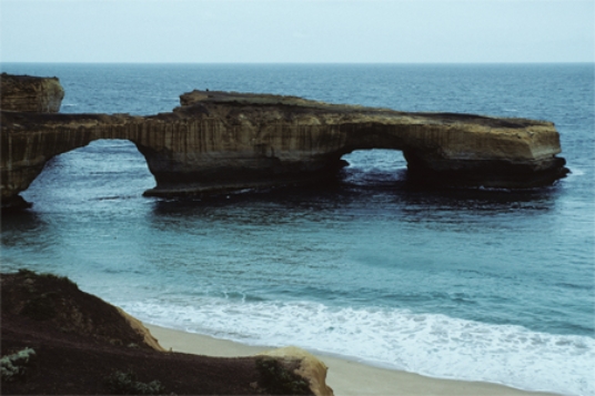 <strong>The sea cave in this photograph formed by </strong> A)erosion of a promontory by waves. B)erosion by blowing beach sand. C)removal of rocks by giant lobsters. D)a rapid drop in sea level.