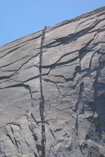 <strong>The joints in the photograph mimic topography, indicating that they formed  </strong> A)while the granite was still molten. B)while the rocks were still buried at great depth. C)when the weight of overlying rocks was unloaded, allowing expansion along the joints. D)along a subduction zone. <div style=padding-top: 35px> 