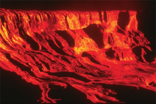 <strong>Comparing these two photographs, which eruption has lower viscosity magma? </strong> A)the fluid cascade of lava B)the circular volcanic feature C)they could have the same viscosity D)there is no way to tell
