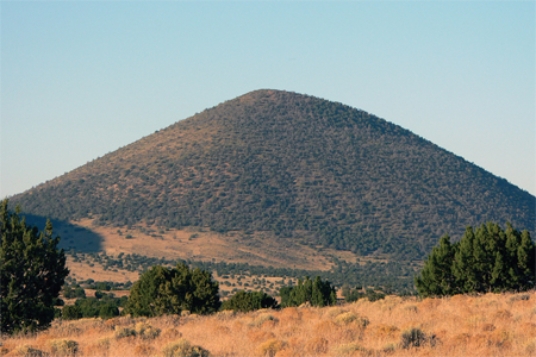 <strong>What types of rocks would be most common in the small volcano in this photograph? </strong> A)scoria and other vesicular basalt B)basalt mostly formed in lava flows C)felsic and intermediate lava flows D)welded tuff and tephra E)None of these.