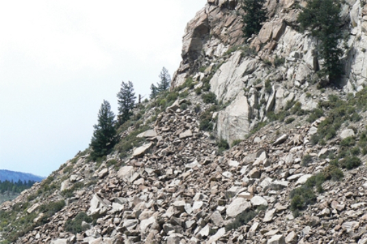 <strong>Which of the following surface environments is the most likely site for deposits in this photograph? </strong> A)steep mountain front B)river channel C)sand dunes D)beach E)lake