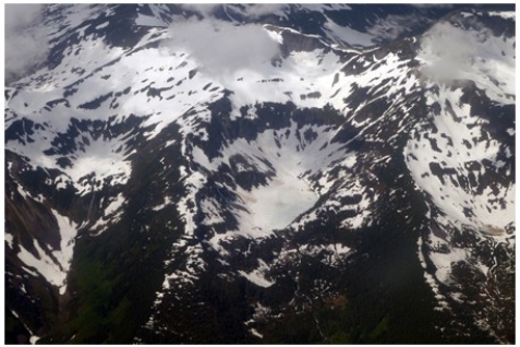 <strong>The circular-shaped mass of ice shown in the center of the photograph below is a(n) </strong> A)cirque glacier. B)ice sheet. C)snowfield. D)ice shelf.