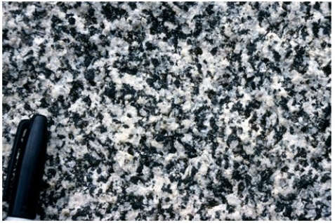 <strong>What texture is displayed by the igneous rock in this photograph?  </strong> A)Vesicles B)Breccia C)Porphyritic D)Glassy E)None of these are correct. <div style=padding-top: 35px> 
