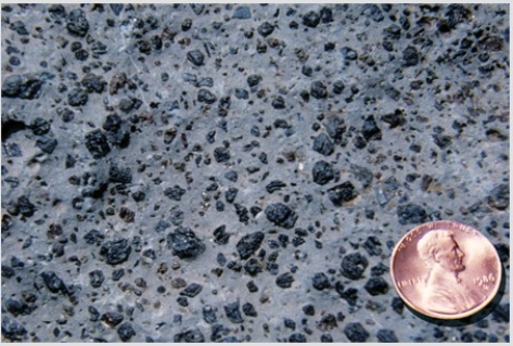 <strong>What texture is displayed by the igneous rock in this photograph?  </strong> A)Vesicles B)Breccia C)Porphyritic D)Glassy E)None of these are correct. <div style=padding-top: 35px> 