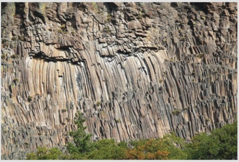 <strong>The type of feature shown in this photograph is  </strong> A)fault scarp. B)columnar joints. C)shear zone. D)folded metamorphic rocks. <div style=padding-top: 35px> 