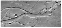 <strong>What do these channels indicate about past events on Mars?  </strong> A)there were explosive volcanic eruptions B)strong winds eroded into a series of volcanic layers C)the surface once had running water that eroded and deposited sediment D)glaciers once covered the entire planet <div style=padding-top: 35px> 