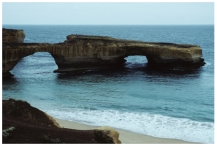 <strong>How did the sea cave in this feature form? </strong> A)erosion of a promontory by waves B)erosion by blowing beach sand C)removal of rocks by giant lobsters D)a rapid drop in sea level
