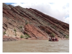 <strong>Where is the oldest layer in this tilted sequence of sedimentary rocks? </strong> A)at the top of the hill in the center of the photograph B)the darkest layers will be the oldest C)the layers on the lower left part of the photograph D)the layers on the right of the photograph