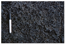 <strong>What type of basaltic feature is shown in this photograph? </strong> A)vesicles B)volcanic bomb C)aa lava flow D)pahoehoe lava flow E)pyroclastic flow