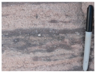 <strong>What type of eruption formed this flow-banded rhyolite? </strong> A)a viscous lava flow B)a pyroclastic column C)a pyroclastic flow D)a lava that broke apart while it flowed E)a lava fountain