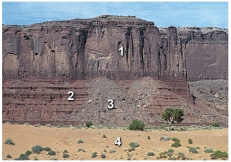 Which locations contain rocks that are in place (part of the bedrock)?