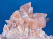 <strong>What does the shape of these crystals indicate about the environment in which they formed?  </strong> A) They formed at great depth and under very high pressures. B) They formed from cold water that was moving rapidly through the rocks. C) They formed into a space filled with water rather than solid rock. D) They grew during an explosive volcanic eruption. <div style=padding-top: 35px> 