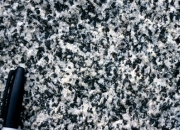 <strong>What texture is displayed by the igneous rock in this photograph? </strong> A) vesicles B) breccia C) porphyritic D) glassy E) none of these