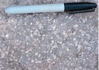 <strong>What does the texture of this rock indicate about its cooling history? The magma cooled: </strong> A) entirely at the surface B) for a while at some depth and then rose to the surface where it finished solidifying C) slowly under relatively deep conditions D) slowly in the presence of water