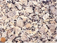 <strong>What does the texture of this rock indicate about its cooling history? The magma cooled: </strong> A) entirely at the surface B) for a while at some depth and then rose to the surface where it finished solidifying C) slowly under relatively deep conditions D) slowly and underwater