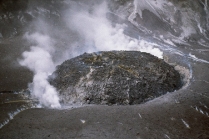 <strong>Comparing these two photographs, which eruption has lower viscosity magma? </strong> A) the fluid cascade of lava B) the circular volcanic feature C) they could have the same viscosity D) there is no way to tell
