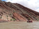 <strong>Where is the oldest layer in this tilted sequence of sedimentary rocks? </strong> A) at the top of the hill in the center of the photograph B) the darkest layers will be the oldest C) the layers on the lower left part of the photograph D) the layers on the right of the photograph
