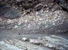 <strong>This photograph shows an upper unit with fragments and a lower unit with tilted layers. Which of the following statements is true? </strong> A) the upper unit is younger because it is on top B) the upper unit is younger because it contains pieces of the underlying unit C) the lower unit is older because it was tilted and eroded before deposition of the upper unit D) all of these