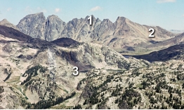 <strong>Which numbered features) on this photograph are consistent with the presence of glaciers sometime in the past?  </strong> A) 1, an arête B) 2, U-shaped valley C) 3, tarn D) all of these <div style=padding-top: 35px> 