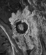 <strong>This radar image of a crater on Venus shows:  </strong> A) an area of light-colored, smooth rocks around the crater B) that the crater contains dark-colored, rough rocks C) a central area of dark-colored hematite surrounded by light-colored feldspar D) the roughness of the materials, but does not indicate whether the rocks are light or dark colored <div style=padding-top: 35px> 