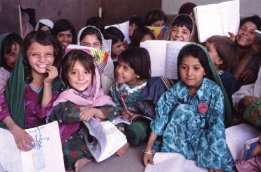 <strong> One major effort in developing countries is illustrated in the photo above.This is an effort to</strong> A)emphasize environmental policy by moving classrooms outdoors. B)teach foreign languages in schools. C)increase the number of girls in schools. D)encourage better nutrition by teaching children how to raise chickens.