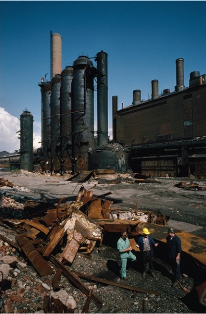 <strong>For this question,refer to the following photograph of an old steel mill being demolished during the 1980s. Which of the following was an important effect of the historical process depicted in the photograph above?</strong> A) A decline in union membership B) A surge in migration to the United States C) Criticism by conservatives for failing to transform the economic status quo D) Debates over the impact of economic consumption on the environment