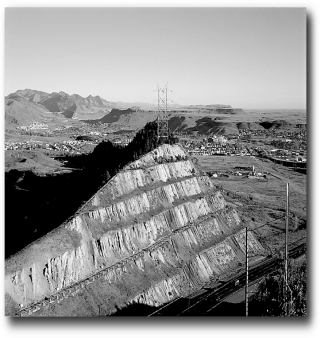 <strong>What is the ultimate control of the development of the landscape,the large road cut,in the following picture? </strong> A) climate B) human activity C) time D) relief
