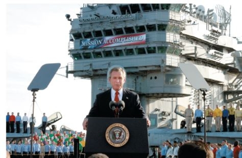 <strong>Questions 15 and 16 refer to the image. Credit: Scott J.Applewhite/AP Images How does the photo illustrate a rally event as it relates to public approval of the president?</strong> A)George H.W.Bush's popularity soared after the Gulf War.-Consider This: If Bush had successfully won reelection,this would have been a rallying event.Unfortunately for Bush,he lost. B)The army backed George W.Bush's military plans. C)George W.Bush's popularity surged after initial success in Afghanistan. D)George W.Bush convinced Americans to support TARP.