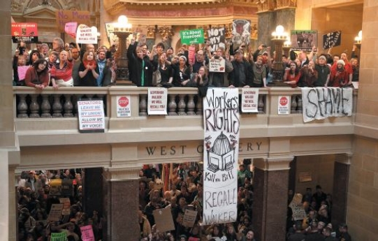 <strong>  Credit: Justin Sullivan/Getty Images News/Getty Images  -Why might the people protesting seek to recall the governor?</strong> A)He failed to protect consumers from unsafe products. B)He refused to protect the interests of businesses within an industry.-Consider This: Trade associations try to protect the interests of business within an industry. C)He took collective bargaining rights away from public employees. D)He provided jobs for the unemployed. <div style=padding-top: 35px> 